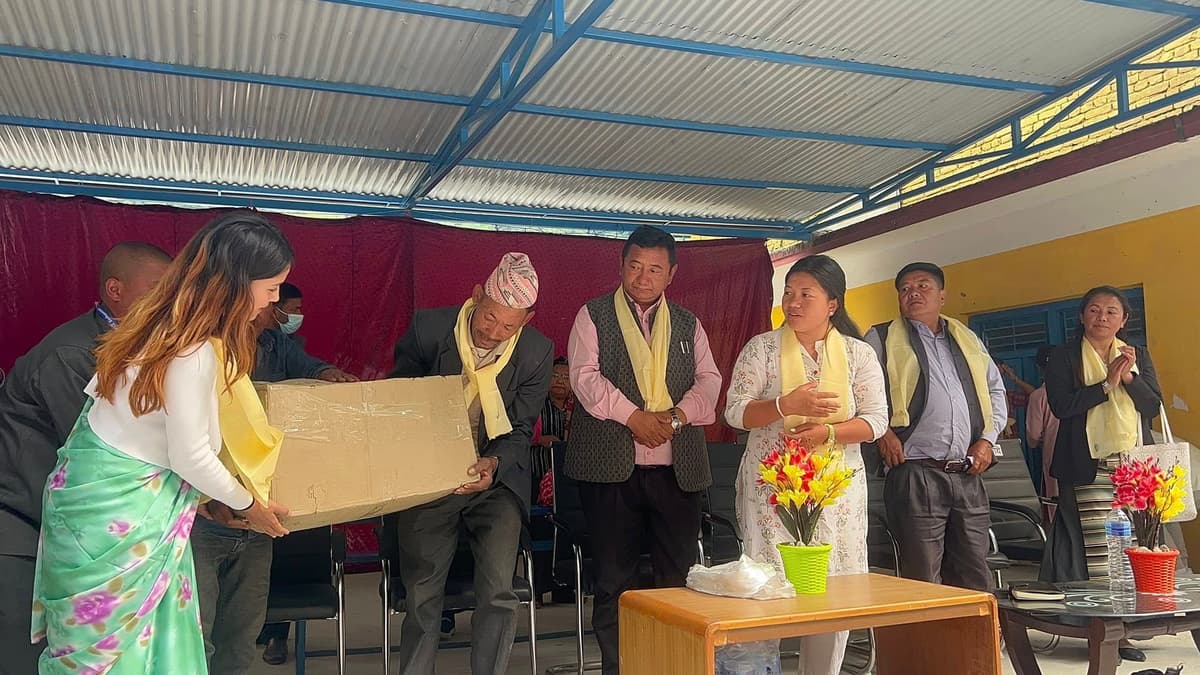 Pasang Dolma Sherpa handing over sports materials and stationery to Tatopani Basic School, Sindhupalchok